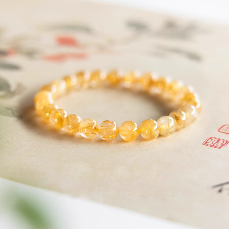 Citrine bracelet resting on traditional calligraphy paper