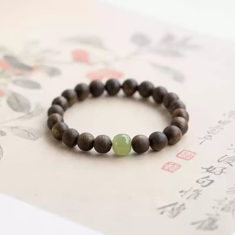 Bracelet displayed on a Chinese calligraphy scroll