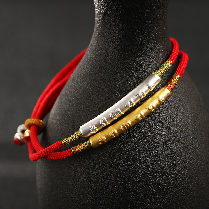 Two bracelets on black ceramic jar
