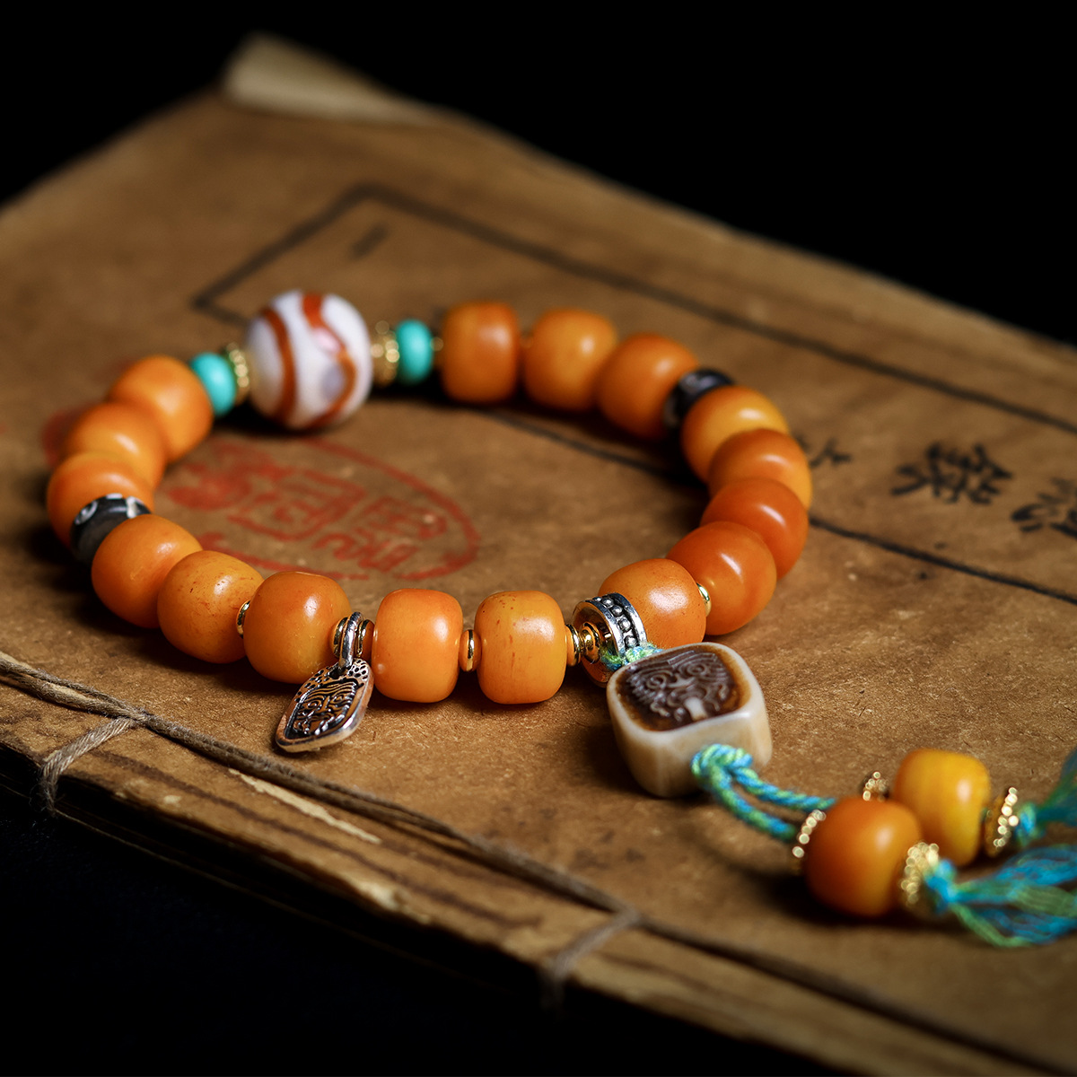 Alternate angle of the bracelet on an old book