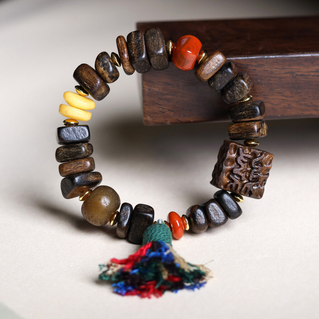 agarwood bracelet on wooden jewelry stand side view