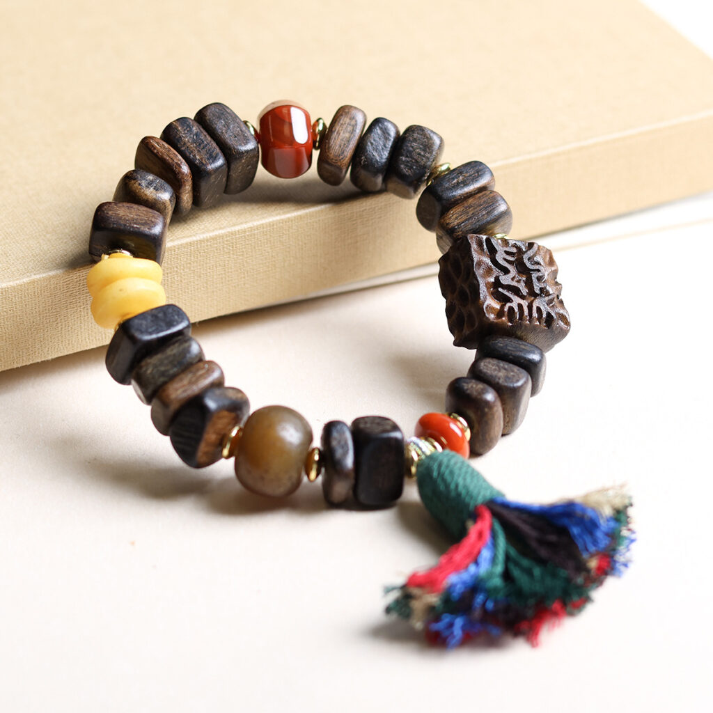 close-up of tibetan tassel on agarwood bracelet