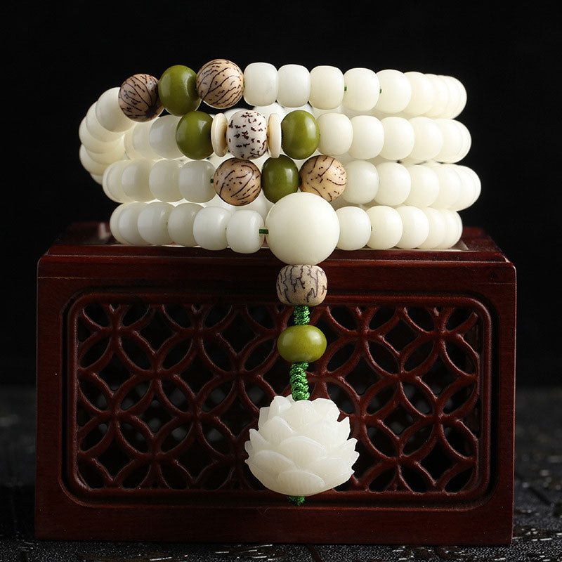 Bodhi seed mala bracelet placed on wooden jewelry box