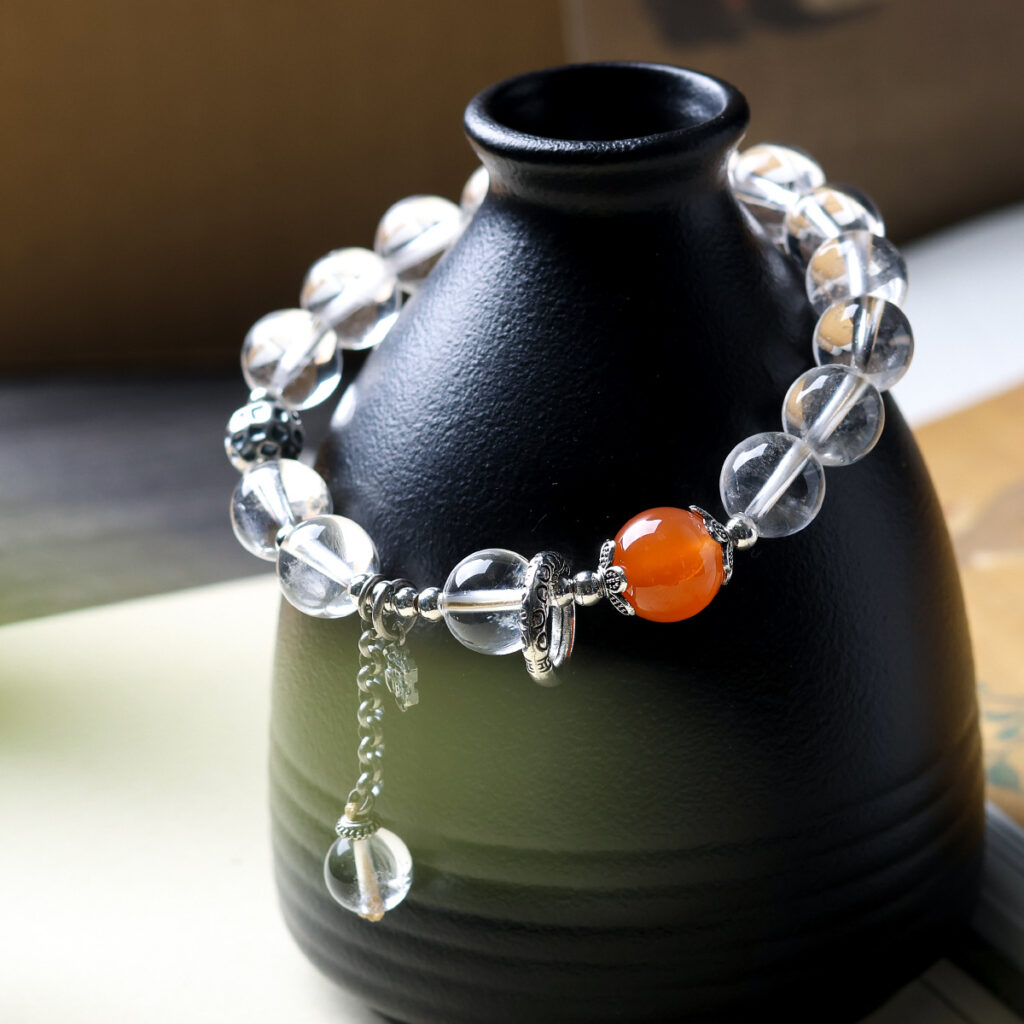 Clear quartz bracelet styled around a black ceramic flask