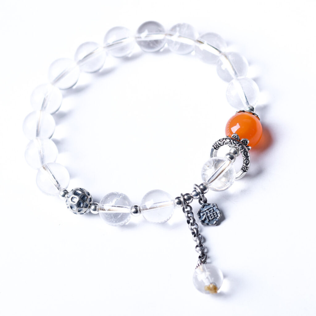Minimalist clear quartz bracelet on a pure white background