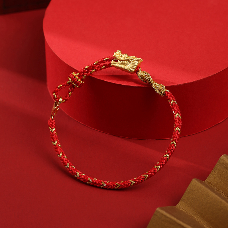 Full view of red string bracelet with golden dragon head