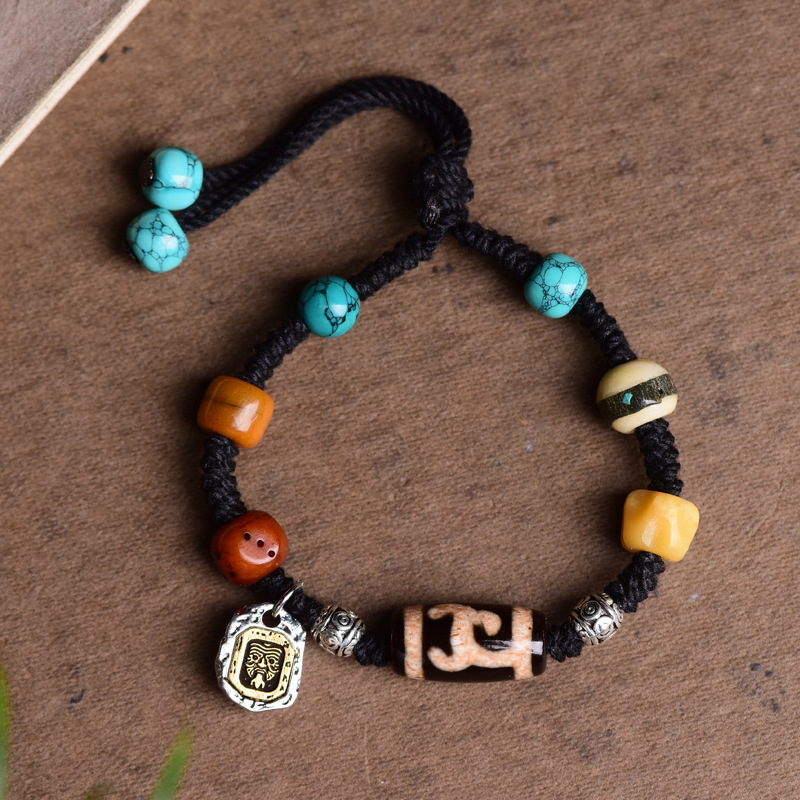 Black Tibetan rope bracelet with dzi bead, yak bone, turquoise and silver tag