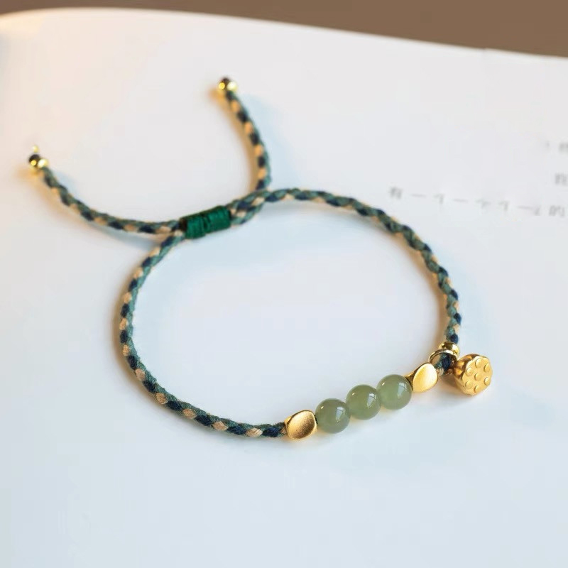 Green jade bracelet string with Tibetan brass beads and lotus charm, 45-degree angle