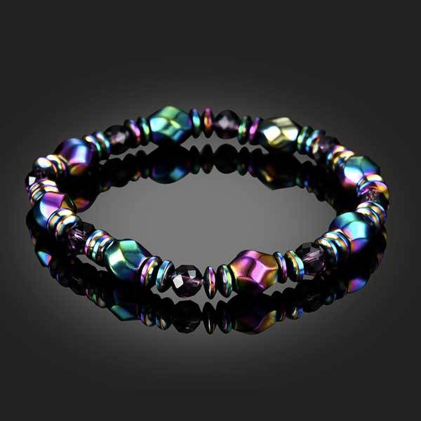 Rainbow hematite bracelet on glass table with reflection