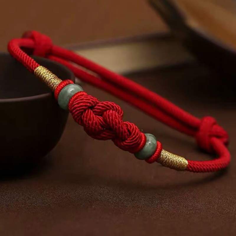 Red Tibetan string bracelet with jade beads close-up
