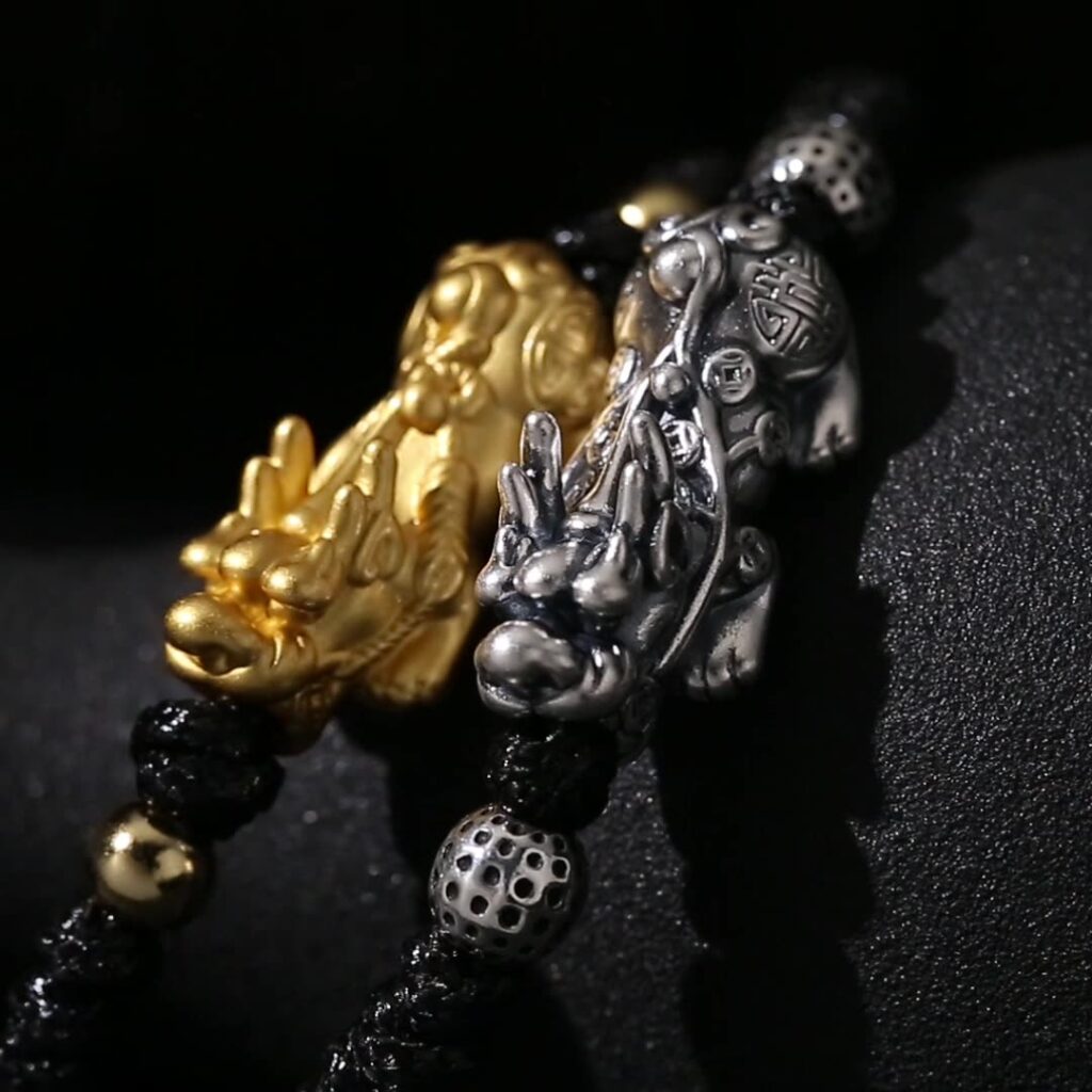 Close-up of silver and gold Pixiu Charm Bracelet details
