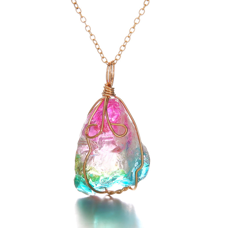 Detail view of raw rainbow crystal pendant on white background