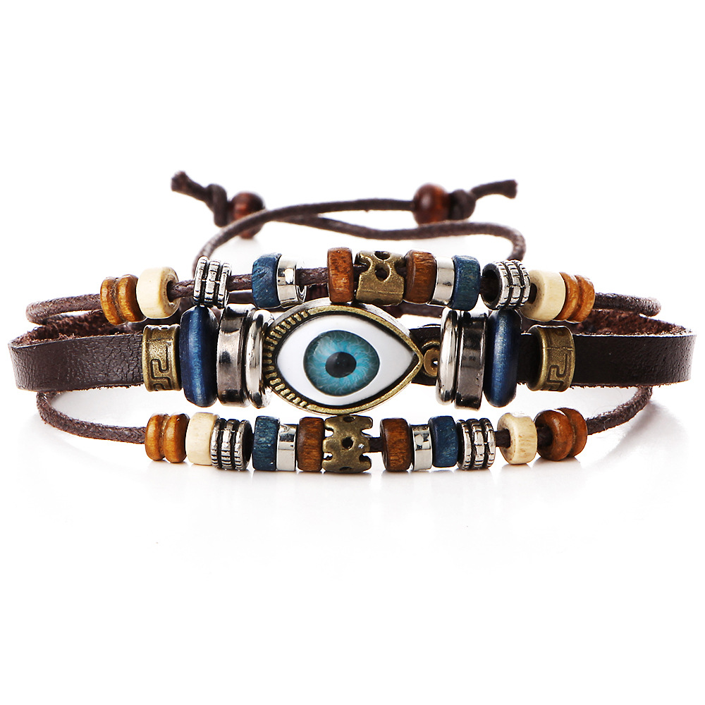 Close-up of evil eye charm on leather bracelet