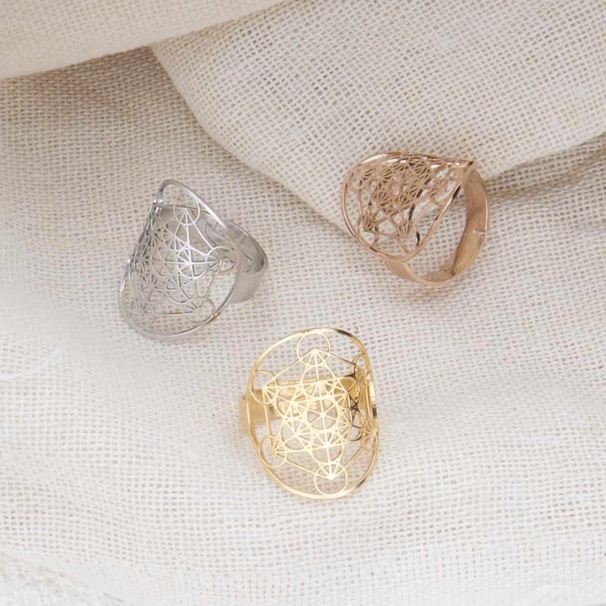 Gold, silver, and rose gold Metatron Archangel Rings displayed together